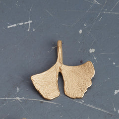 zarter-handgefertigter-ginkgo-anhänger-mit-feiner-struktur-von-echten-ginkgoblaettern-abgeformt-ohne-kette-in-sterling-silber-vergoldet-oder-echtgold-aus-aus-unserer-goldschmiede-in-frankfurt-auch-in-fairtrade-gold-erhaeltlich-zackige-geschwungene-form-mit-einem-schlitz
